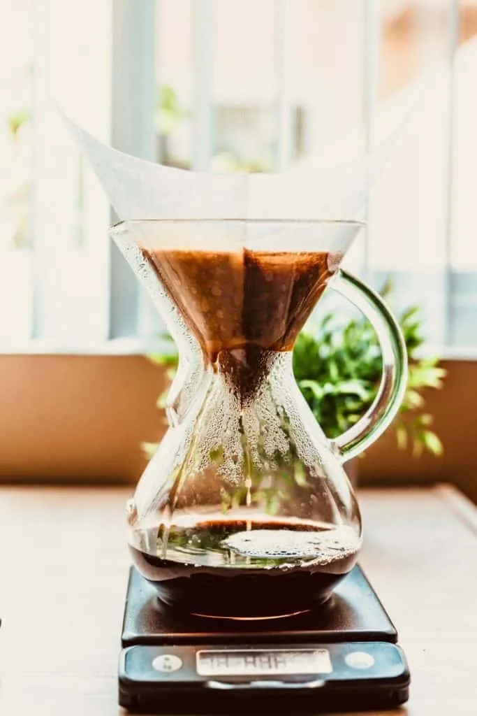 Pouring water through a chemex coffee maker