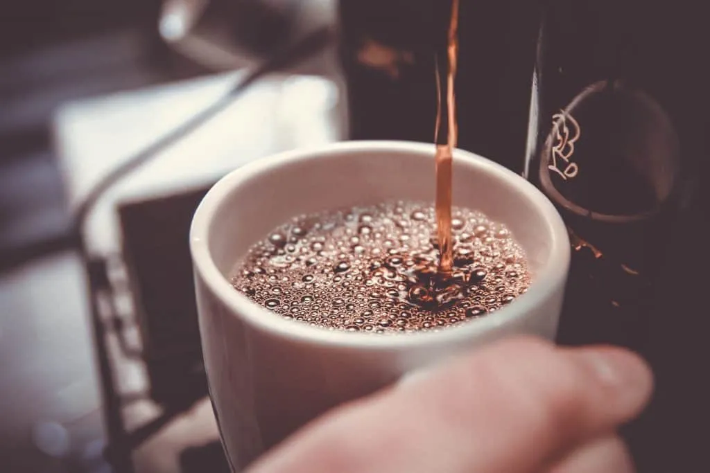 Black coffee being poured into a cup