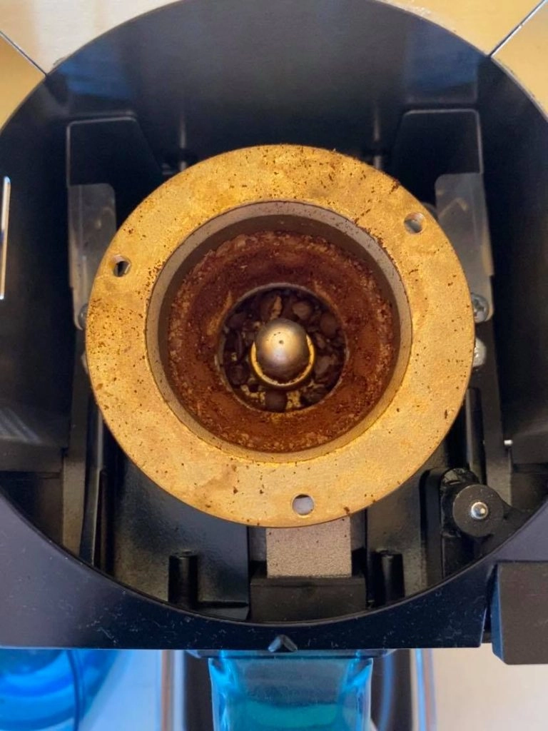 Photo of coffee grinder with built up coffee dust before cleaning