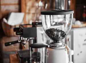 Image of Mazzer Mini grinder next to an espresso machine